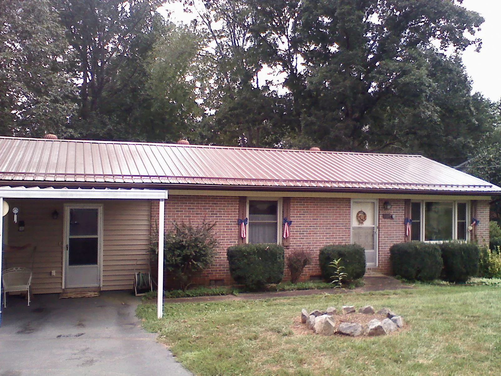 Bronze metal roof and carport on a brick ranch home — Roof Repair work by our crew in Ronald